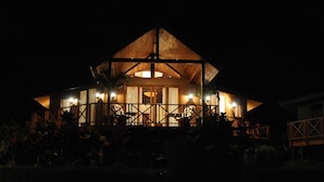 A large, well-lit building with a prominent wooden structure and multiple windows.