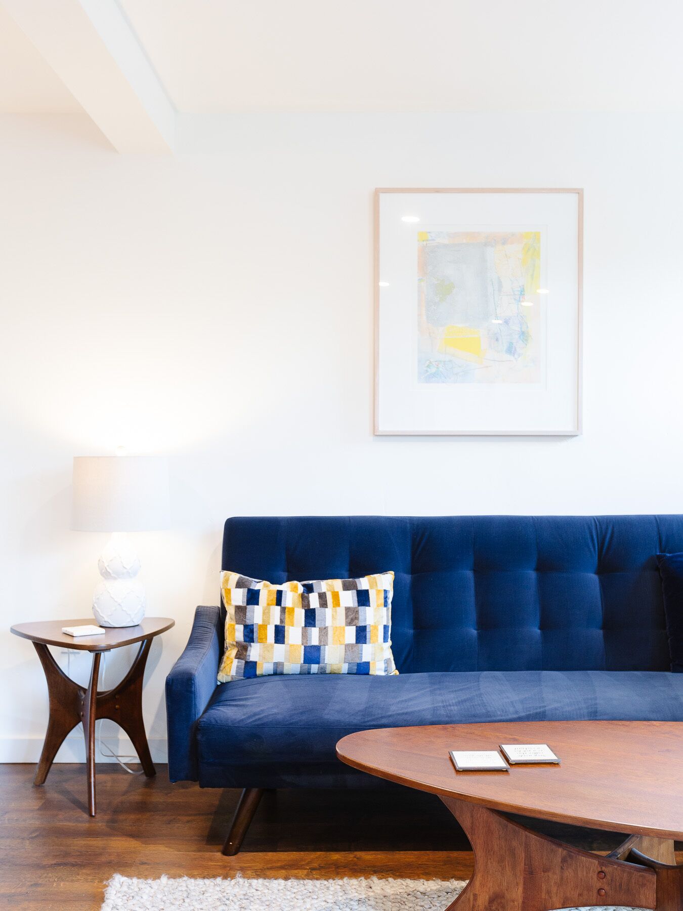Couch and a bit of art in a bright and airy space.