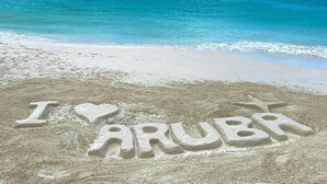 A beach with the words "I love Aruba" carved in the sand. - Piece of Paradise... Eagle Beach Villa with Private Pool;  Great Location! (Aruba)