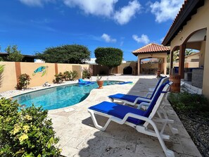 A swimming pool with lounge chairs, a mural of a sea turtle, and a covered patio area. - Piece of Paradise... Eagle Beach Villa with Private Pool;  Great Location! (Aruba)