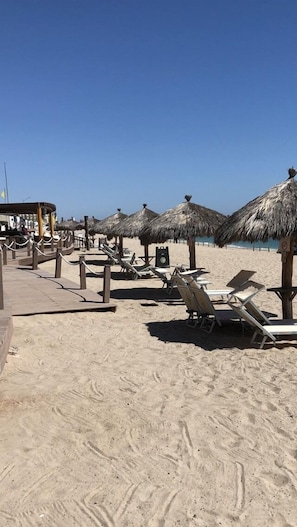 On the beach, sun-loungers