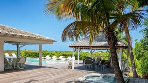 A wooden deck with a hot tub, lounge chairs, and a gazebo overlooking a pool and ocean. - Whispers of the Caribbean: Villa Azur’s Private Pool, Jacuzzi & Timeless Luxury (Les Terres Basses)