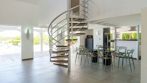A modern kitchen with a spiral staircase leading to an upper level. - Whispers of the Caribbean: Villa Azur’s Private Pool, Jacuzzi & Timeless Luxury (Les Terres Basses)