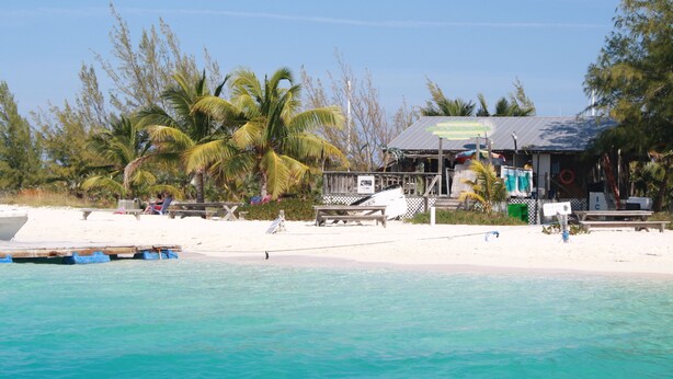 A beachside building with a signboard, a dock, and a lifebuoy. - HOOPERS BAY PRIME BEACHFRONT  KING or TWIN  STUDIO  and with STARLINK fast WIFI (Georgetown)