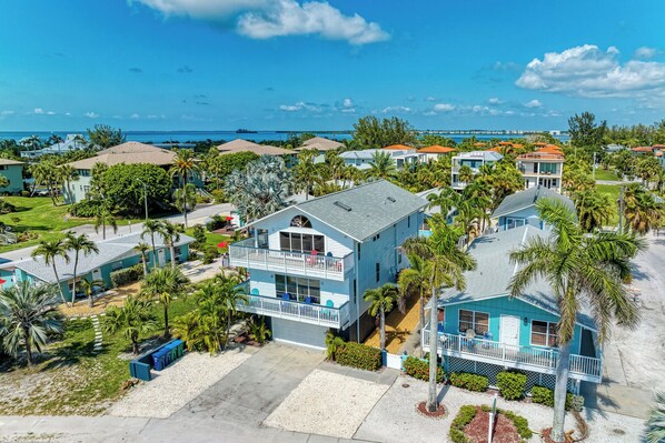 A coastal residential area with houses featuring balconies and views of the ocean.