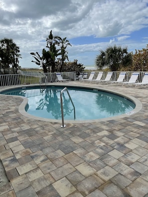 A pool area with lounge chairs and a view of the ocean. - Cancellation Special Aug 15-22, 2026 - IRB Direct Beach Front Corner Condo (Indian Rocks Beach)
