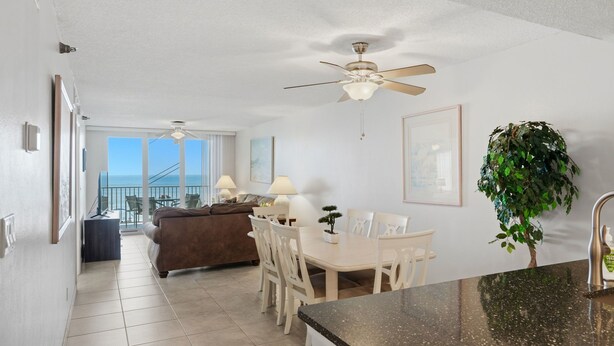 A hotel room with a balcony, a dining area, and a kitchen. - Special Nov 28 - Dec 19, 2026 - IRB Direct Beach Front Corner Condo (Indian Rocks Beach)