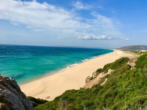 On the beach, sun loungers, beach towels