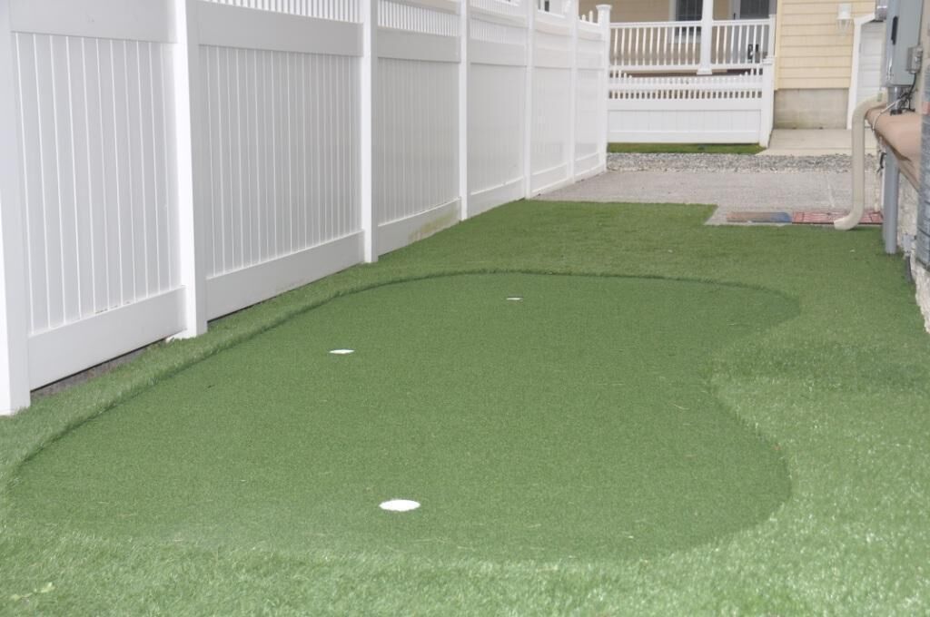A white fence with a small deck area.