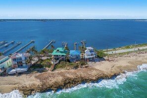 A coastal property with multiple buildings, a pier, and a beach. - Heaven Can't Wait:  ON the BEACH!! Heated pool + hot tub, private dock. 7BR/5BA (Stuart)
