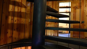 A spiral staircase in a wooden interior with a view of a room below. - RIVER IN YOUR FRONT YARD!/Suspended Fireplace/Perfect for Families & Groups/PETS (Red River)