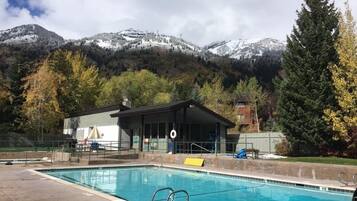 Relax by the serene pool surrounded by breathtaking mountain views.