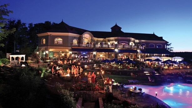 A large hotel with multiple dining areas and a swimming pool.