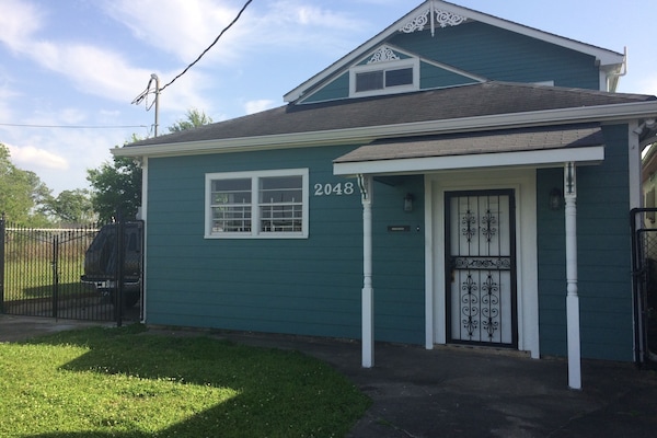 Exterior front with locked gated driveway on side of house