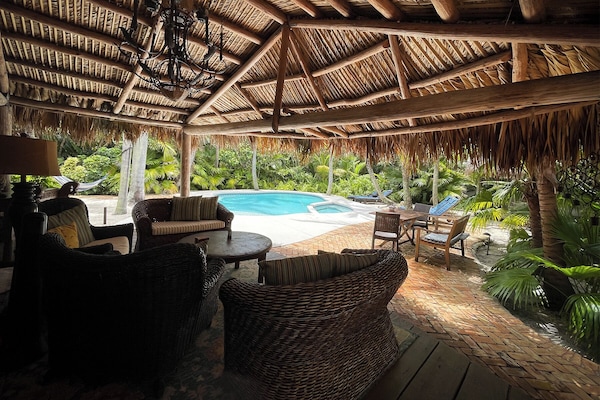 The outdoor living room under the Chickee provides a truly tropical flare.