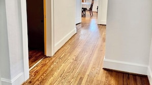 A hallway with wooden flooring, white walls, and a ceiling light fixture. - Fabulous Location Updated 3bd/2bth Home (Birmingham)