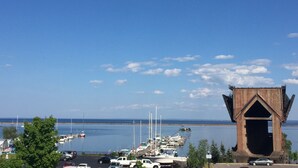 A marina with boats, a large wooden structure, and a clear blue sky.