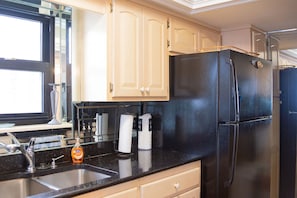 Enjoy cooking in this well-equipped kitchen with a stainless steel sink and ample countertop space.