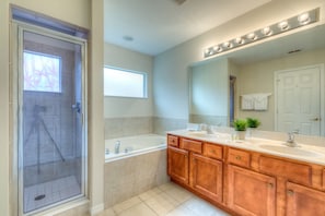 Bathtub, hair dryer, towels, toilet paper
