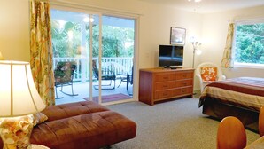 A bedroom with a bed, a dresser, a television, a chair, and a lamp. - Wir sprechen Deutsch. Lovely studio with kitchenette, spacious lanai,TV and WiFi (Kailua Kona)