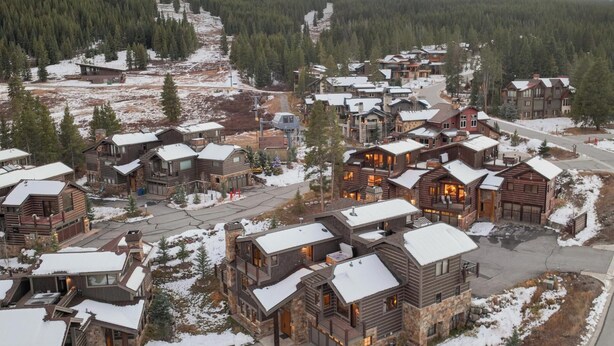A resort with multiple wooden cabins, a ski lift, and a mountainous backdrop. - Retreat at Lewis Ranch: Walk to Lift, Private Hot Tub, Shuttle, Gas Grill (Copper Mountain)