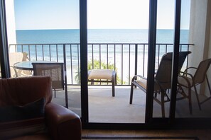 A balcony with a view of the sea, furnished with a sofa, chairs, and a table. - Oceanfront Bold & Stately  Condo_Top Listing 2021 Books Early-Family Friendly  (Myrtle Beach)