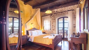 A traditional bedroom with a wooden bed, a nightstand, a dresser, and a mirror. - Purple villa Malotira - 1 bedroom -veranda -roof terrace - mountain and sea view (Chania)