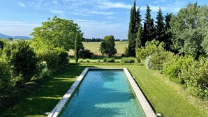 A rectangular swimming pool surrounded by lush greenery and trees, with a clear sky above. - Unique house with air con, wine country, pool 18x5, close Avignon (Cairanne)