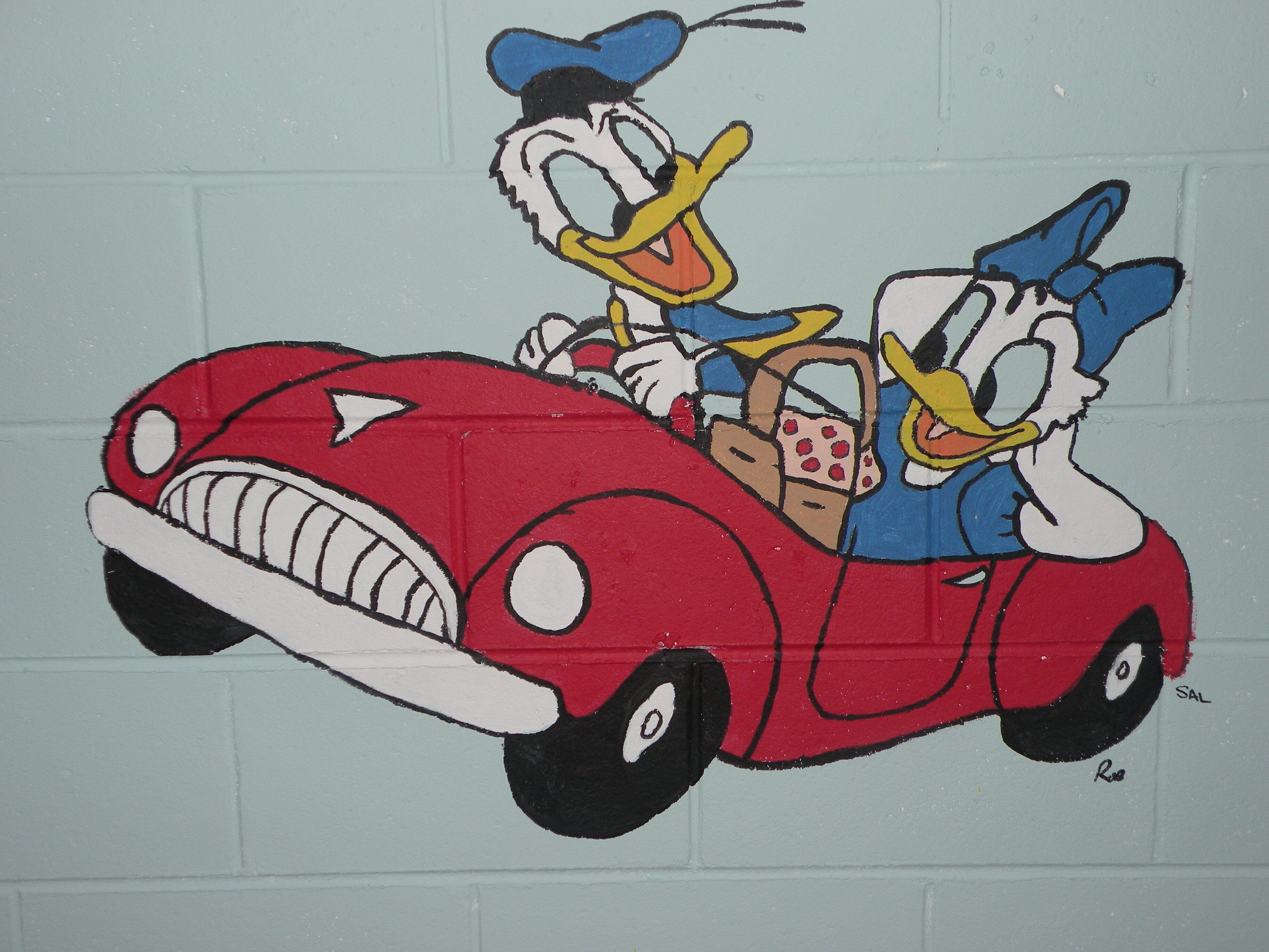 A cartoon character in a red car with a steering wheel.