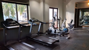 A gym with treadmills, stationary bikes, and elliptical machines. - Ultra modern bungalow in Jakkur (Bengaluru)