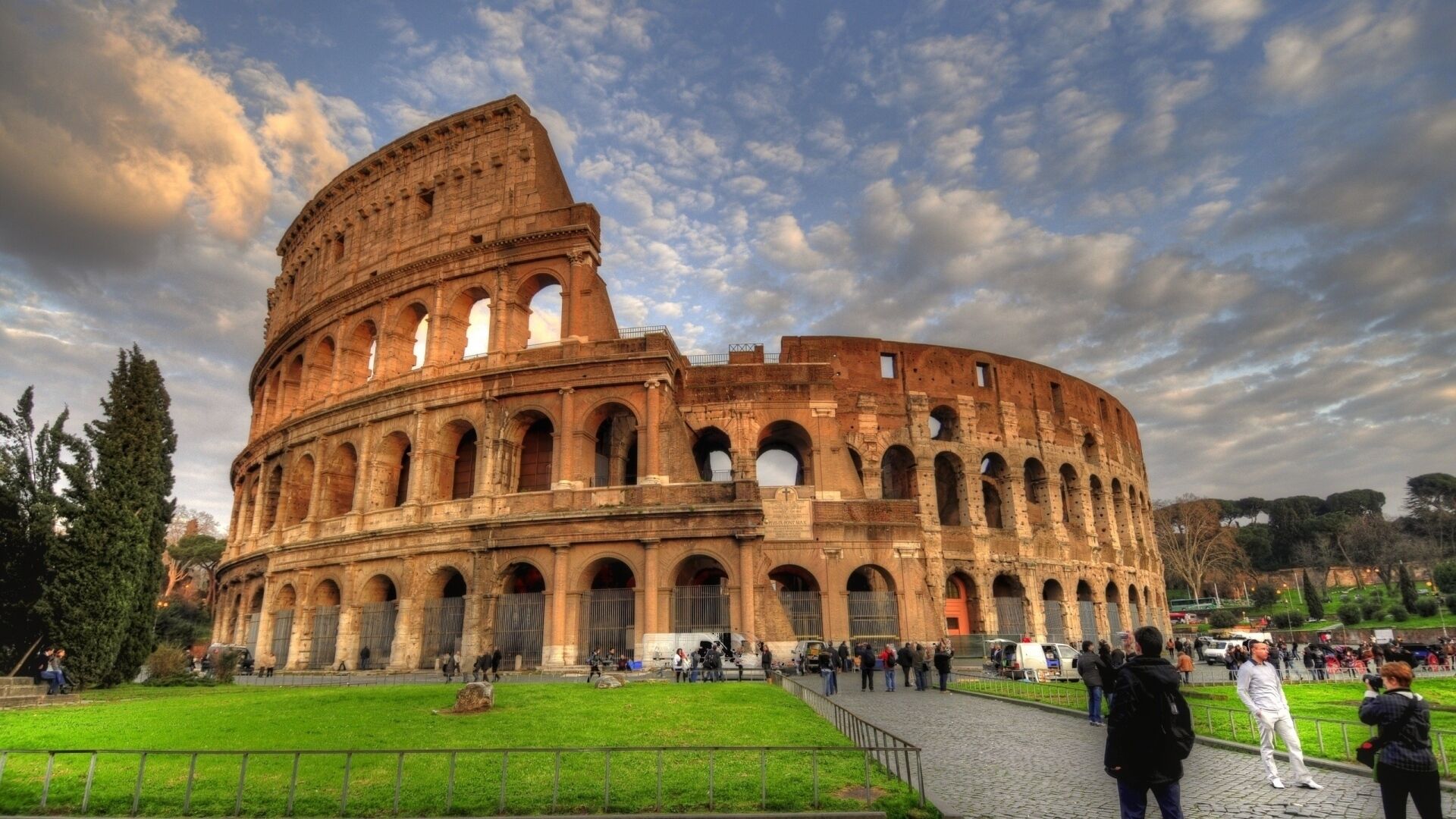 A large, historic amphitheater with multiple levels of arches and a central open area.