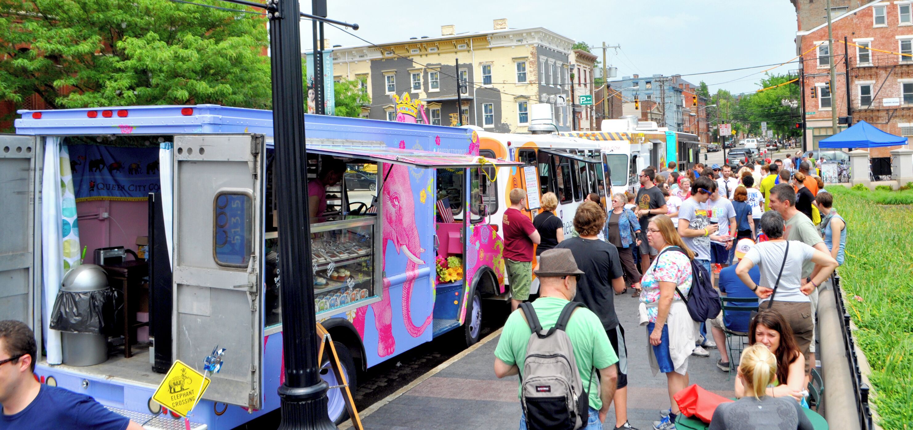 A food truck with a colorful elephant design parked on a street.