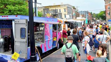 A food truck with a colorful elephant design parked on a street.