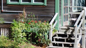 A wooden building with a sign reading "Palace" and a staircase leading to a porch. - Cottage on Beautiful Long Pond  with Fantastic Sandy Lakefront Beach (Plymouth)