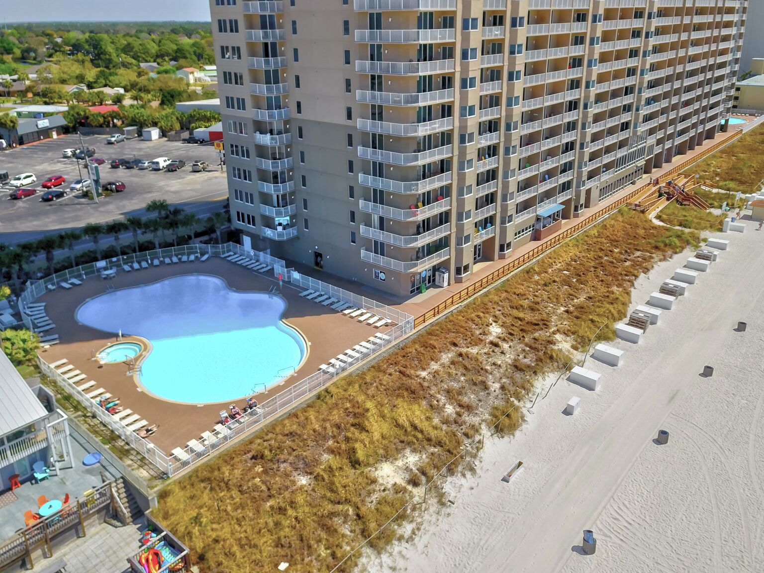 A high-rise hotel with a rooftop pool and beach access.