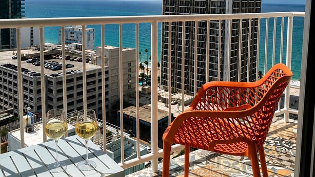 A balcony with a view of the ocean and a Marriott hotel in the background. - Amazing, OCEAN VIEW STUDIO - BALCONY- Wi-Fi -APT has GENERATOR- PARKING Optional (Condado, San Juan)
