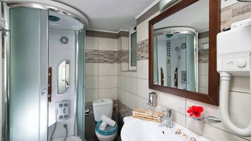 Shower, hair dryer, towels, toilet paper