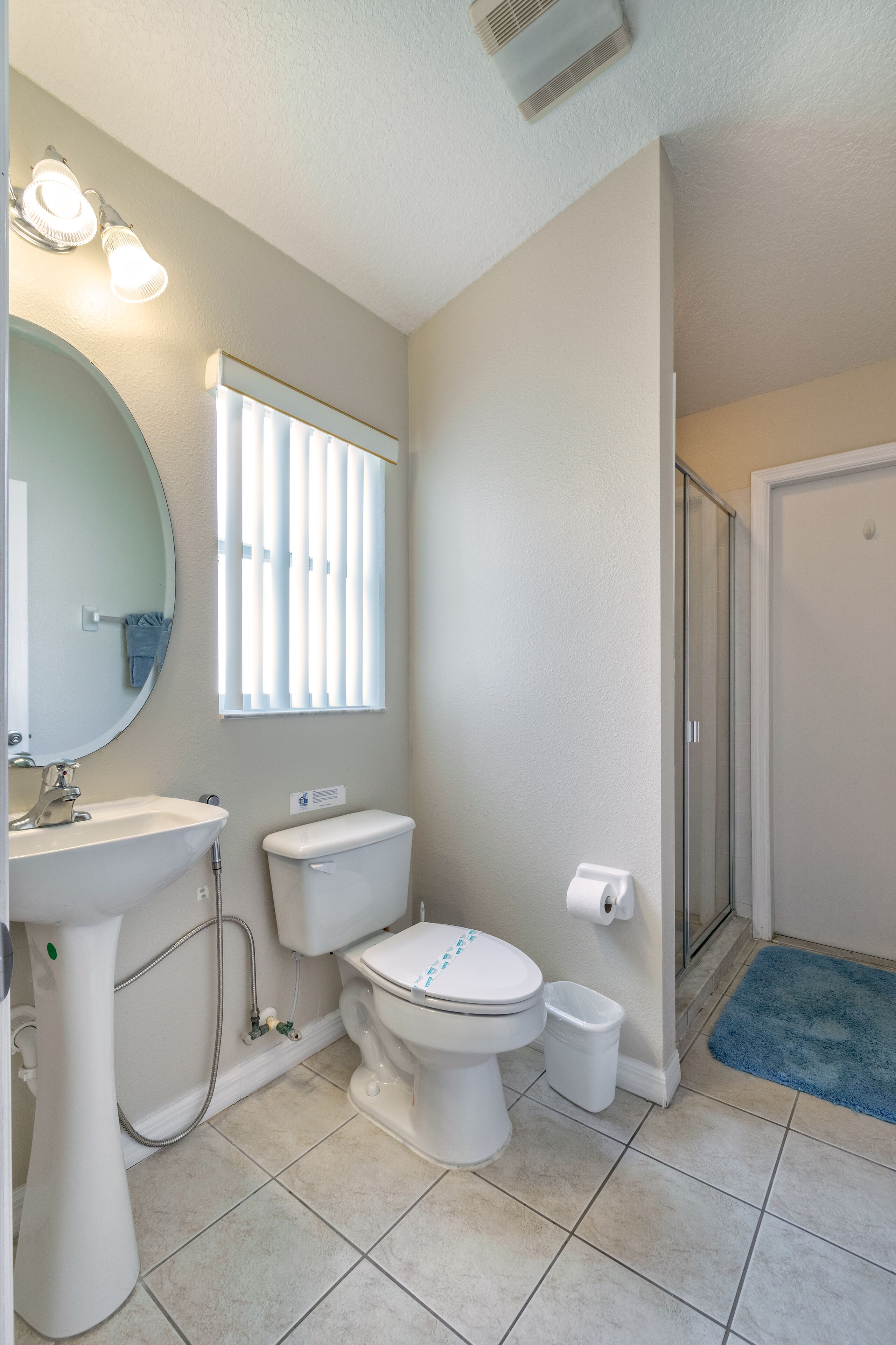 A bathroom with a sink, toilet, and shower.