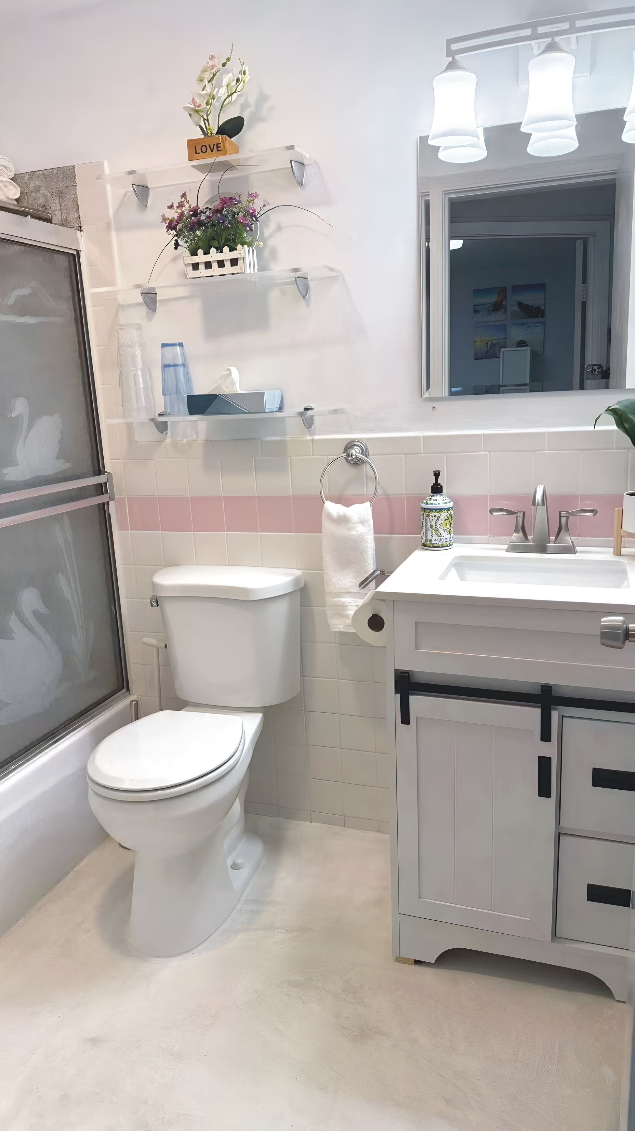 A modern bathroom with a toilet, sink, and shower.