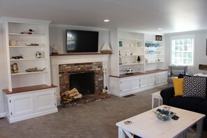 Wood burning fireplace in living room with plenty of family friendly board games