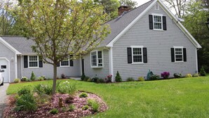 A two-story house with a sloped roof, white trim, and black shutters. - Fabulous 3BR/3BA vacation house in Cotuit that sleeps 8 and only 1 mile to beach (Cotuit)