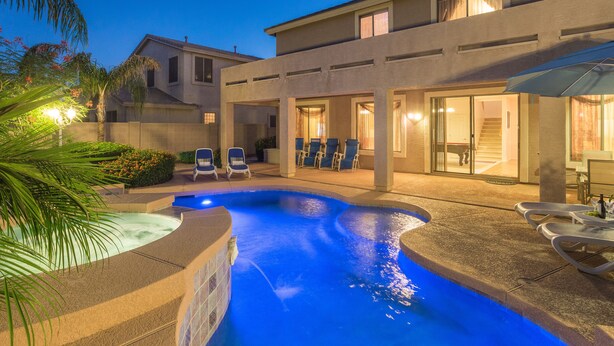 A modern house with a swimming pool, outdoor seating, and a covered patio area. - SUNLAND VILLA - High End resort with heated pool/spa, few minutes to golf course (Goodyear)