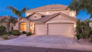 A two-story house with a garage, a driveway, and landscaped garden. - SUNLAND VILLA - High End resort with heated pool/spa, few minutes to golf course (Goodyear)