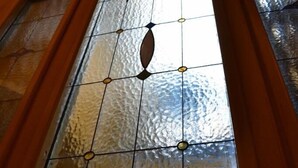 A stained glass door with a geometric pattern and a floral design at the bottom. - Enchanting Florentine Gem: Perfect Location! (florence)