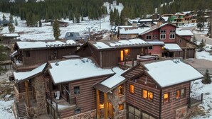 A log cabin-style building with multiple rooms and a ski lift in the background. - Retreat at Union Creek II:  Easy Walk to Lift, Hot Tub, Foosball, Shuttle (Copper Mountain)