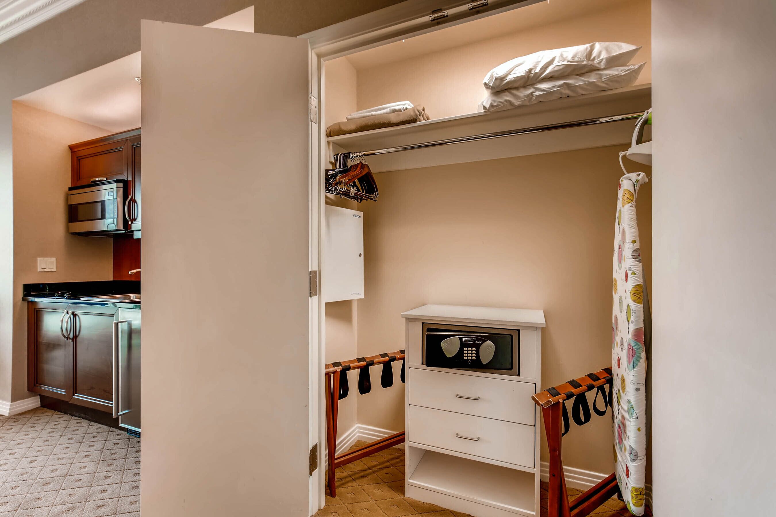 A compact kitchen with modern appliances, a white cabinet, and a microwave.