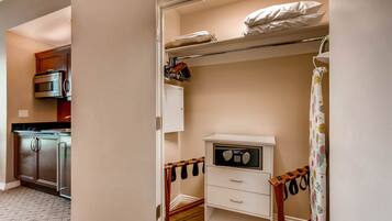 A compact kitchen with modern appliances, a white cabinet, and a microwave.