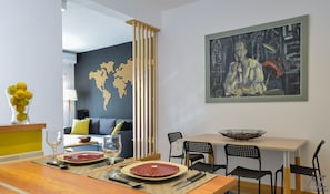 Enjoy meals in this stylish dining area with a world map wall art piece and a large abstract painting.