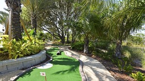 A miniature golf course with a green fairway, a white circle, and a flag marked '14'. - EPIC VALUE-Disney Retreat! Magical Kid Friendly! Resort! (Davenport)