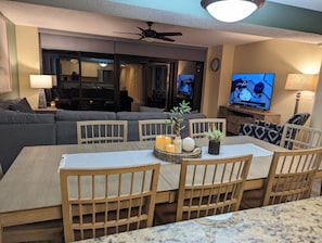 Enjoy meals in the central dining area with a wooden table and comfortable seating.